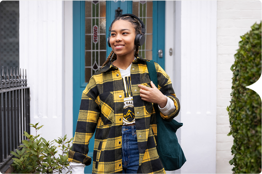 Photograph of a young woman outside wearing headphones, asthma inhaler, lower carbon footprint, GSK 220735 Study.